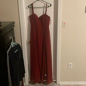This beautiful long sleeve less dress is brand new, it is more a color burgundy